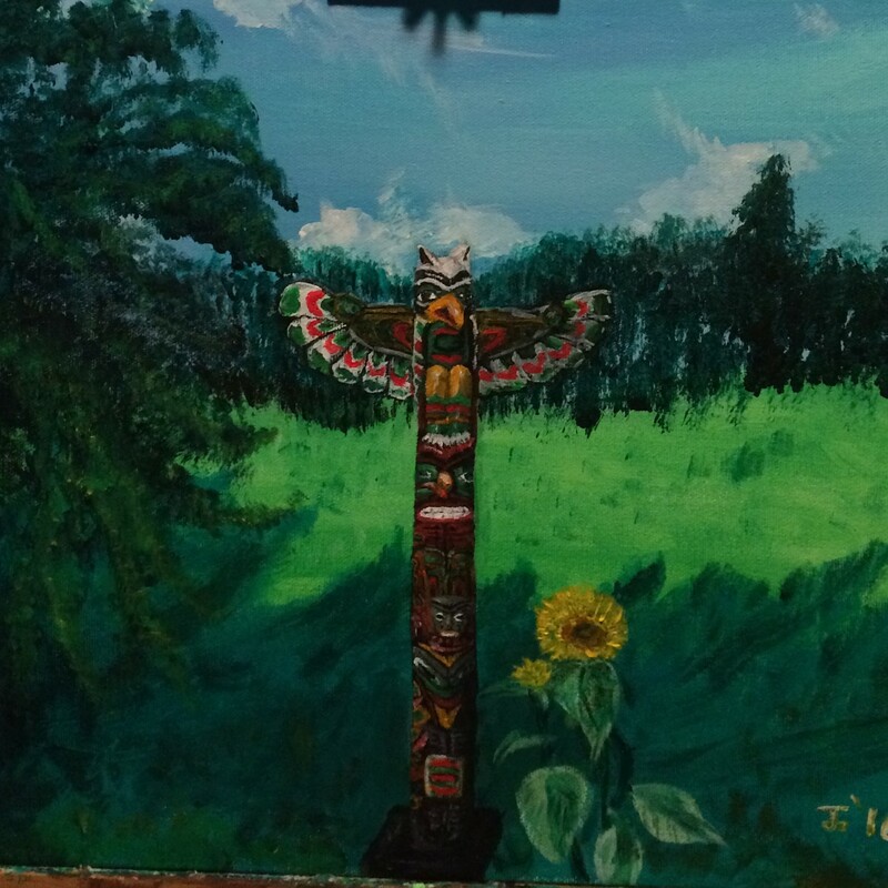 Totem pole purchased at Primitive Designs  next to a sunflower in our yard.